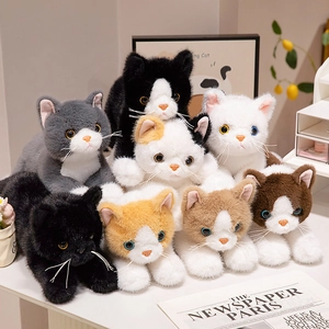 Lifelike plush cat dolls in various colors resting in a cozy home setting