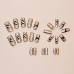 Silver glitter press-on nails with black stars and Magic text in 24 pieces set