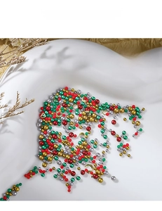 Close-up of festive Christmas nail art kit with colorful beads and metal charms
