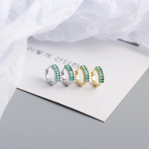 Macro shot of S925 sterling silver hoop earrings with emerald-cut green zircon inlay