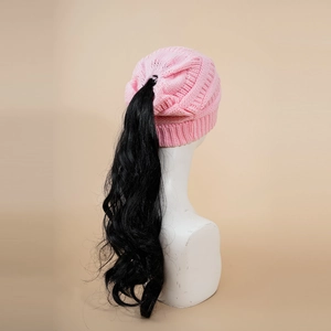 Pink knit ponytail hat detail showing functional top opening with long black wavy hair