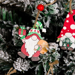 Detailed view of colorful wooden gnome ornaments hanging on a snowy Christmas tree branch