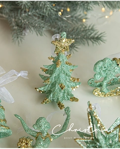 Detail of green and gold Christmas tree butterfly ornaments with sheer organza ribbon