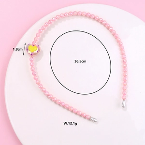 Detailed view of a pink beaded headband with heart charm, 1.8cm width and 36.5cm length