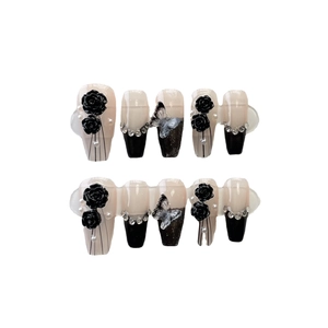 Handmade press-on nails featuring black camellia, silver butterflies and crystals