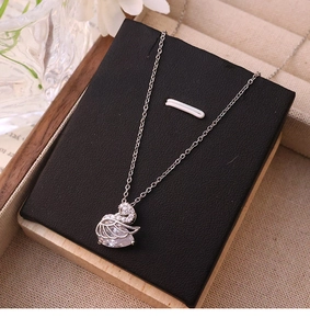 Detailed view of swan pendant necklace with sparkling white zircons and teardrop crystal