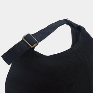 Adjustable black baseball cap featuring a vintage bronze metal slide buckle for custom fit