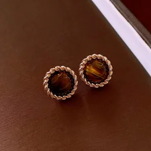 Vintage round tiger eye stone stud earrings with a decorative gold twisted rope metal border