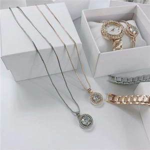 Close-up of elegant rhinestone necklace set with matching watch in a gift box