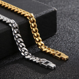 Industrial Cuban link bracelets in polished gold and silver finish on a black texture box
