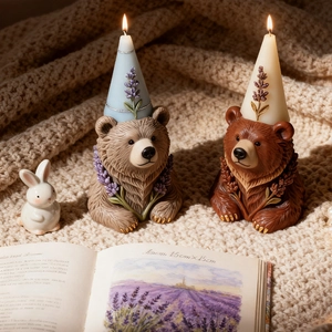 Pair of cute bear candles with lavender relief and pointy hats on a knitted blanket