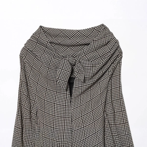 Fashionable houndstooth dress featuring a bow tie neckline and woven texture