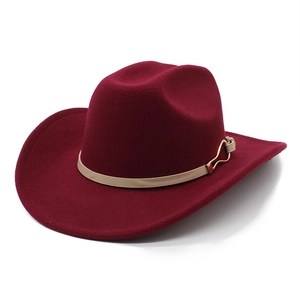 Detail of wine red felt western hat featuring light brown leather band and gold heart buckle