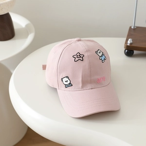 Close-up of pink cotton baseball cap featuring embroidered bears and a smiley star detail