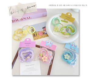 Detail of candy-colored elastic hair ties with cute flower and cartoon charms for girls