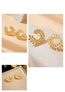 Macro view of gold-plated laurel leaf earrings featuring intricate embossed textures