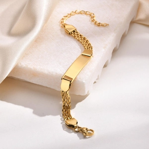 Detail of three-row gold stainless steel mesh bracelet with engravable blank ID bar plate