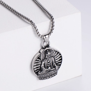 Detail of silver stainless steel Buddha pendant with vintage finish on beaded chain