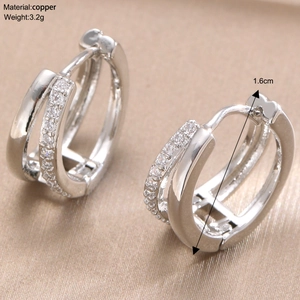 Macro shot of silver geometric double hoop earrings with crystal inlay detail