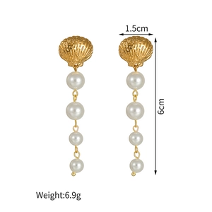 Elegant gold scallop earrings with four cascading white pearls for a coastal look