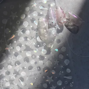 Macro detail of iridescent shell and starfish nail art stickers with MS 566 ocean theme