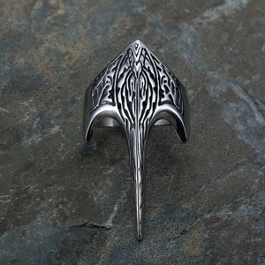 Retro viking crow totem ring in silver punk style on a textured grey rock background