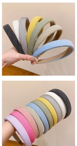 Detail of colorful striped fabric headbands showing thick padded texture and non-slip lining