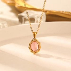 French style gold titanium necklace with pink cat-eye stone pendant on white tray