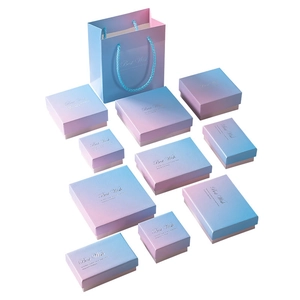 Detailed set of gradient pink and blue jewelry boxes and matching paper gift bags