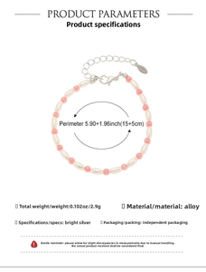 Detail of beaded bow bracelet with pearl beads and adjustable extension chain