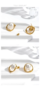 Detail of gold twisted hoop earrings featuring an elegant white pearl on a stone surface