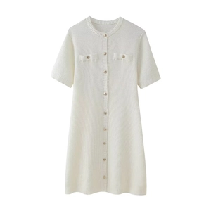 Close-up of white knit dress featuring short sleeves and detailed buttoned front pockets