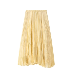 Close-up of light yellow pleated skirt showing delicate textured fabric and fine pleats