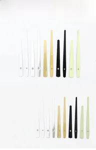 Close-up of model 946 metal clock hands set in white, gold, black, and silver finishes