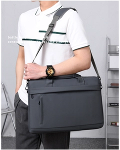 Deep grey large capacity laptop briefcase shown on model with adjustable shoulder strap