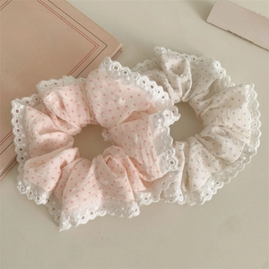 Detail of pink and blue polka dot scrunchies with delicate white lace edging