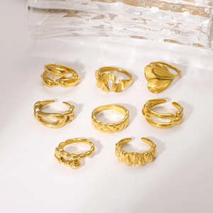 Set of 8 gold dolphin and geometric leaf rings with vintage textured finishes