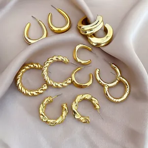 Detail view of 12-piece gold hoop earring set with smooth and twisted C-shape designs