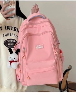 Pink large capacity student backpack featuring multi-layer zippers and white rabbit plush pendant