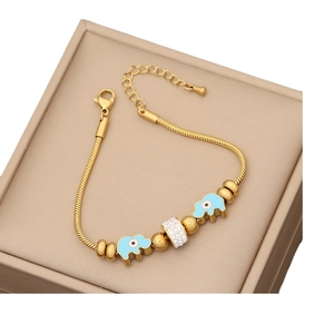 Gold stainless steel bracelet with blue enamel elephants and crystal beads on a gift box