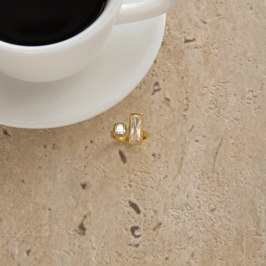 Detail of 18K gold stainless steel open ring with square and baguette zircons on stone