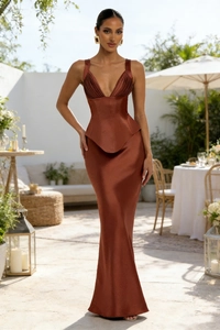 Elegant deep copper satin maxi skirt with a fishtail hem in a sunny outdoor garden setting
