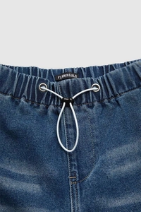 Detail of blue denim trousers with elastic waistband and white adjustable drawstring