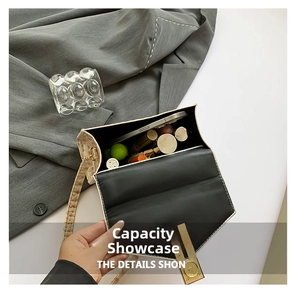 Detail view showing spacious interior of the cream faux croc leather crossbody bag
