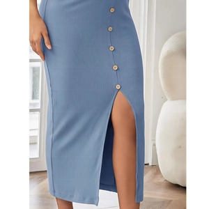 Close-up of ribbed maternity skirt featuring wooden buttons and front slit detail