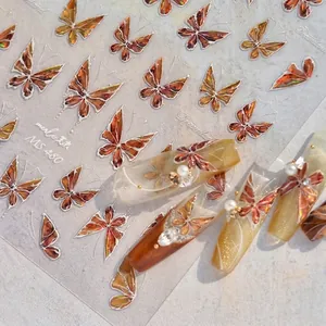 Close-up of amber butterfly nail art stickers with white edges and 3D Dreamland effect