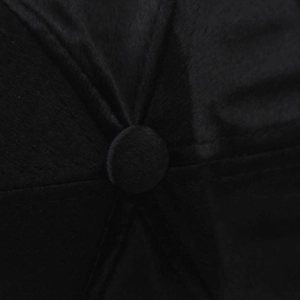 Macro detail of the black suede baseball cap crown featuring a matching fabric top button