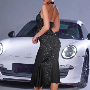 Detail of a sexy black halter dress with silver rhinestones and a fishtail hemline