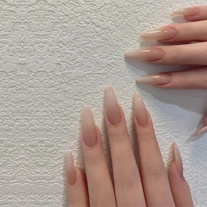 Detailed view of long oval press-on nails with natural nude blush gradient finish
