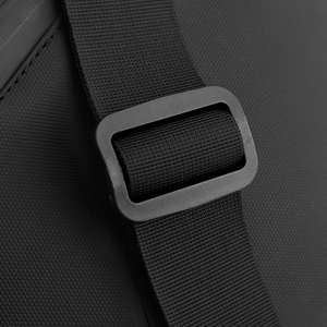 Detail of waterproof crossbody bag showing honeycomb texture and durable buckle strap